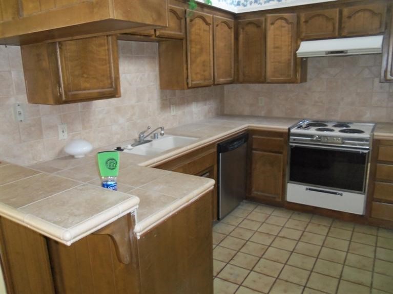 14736 Chaparral Lane, Unit 1 Helendale, CA 92342 - Photo 2 of 5 a kitchen with a sink cabinets and stainless steel appliances