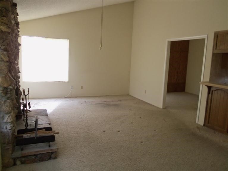 14736 Chaparral Lane, Unit 1 Helendale, CA 92342 - Photo 3 of 5 a view of room with window and a ceiling fan