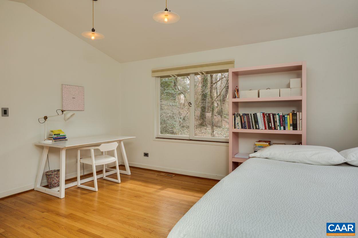 1521 Rugby Road Charlottesville, VA 22903 - Photo 14 of 27 a bedroom with furniture and a wooden floor