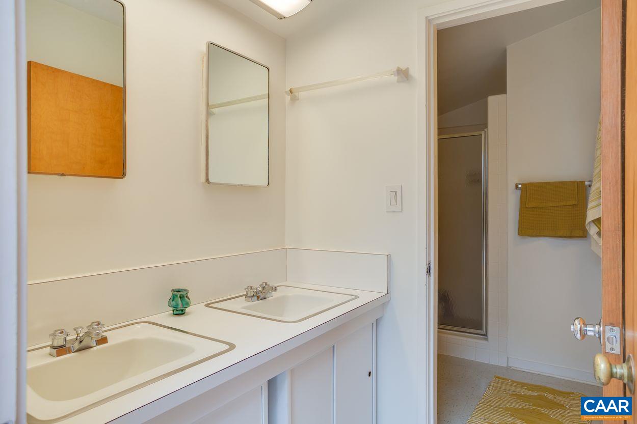 1521 Rugby Road Charlottesville, VA 22903 - Photo 16 of 27 a bathroom with a sink and a mirror