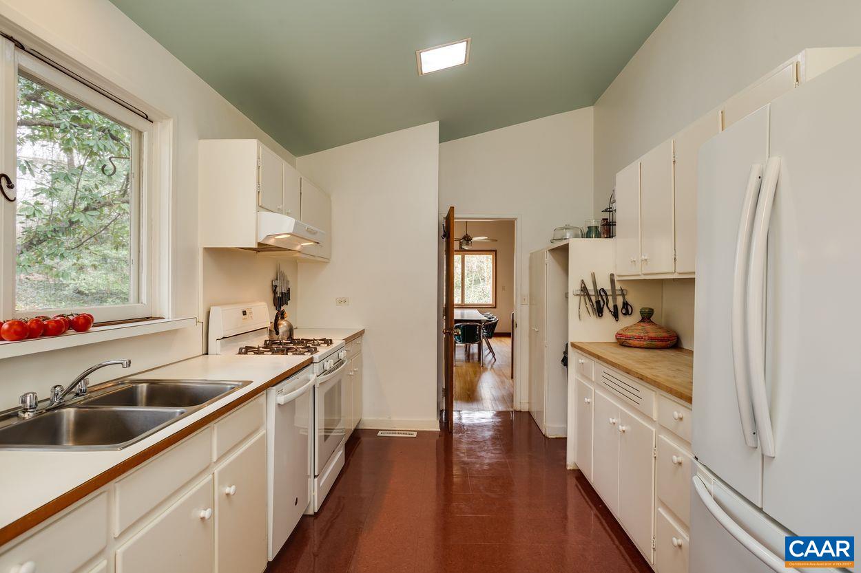 1521 Rugby Road Charlottesville, VA 22903 - Photo 19 of 27 a kitchen with stainless steel appliances a sink a stove and a refrigerator