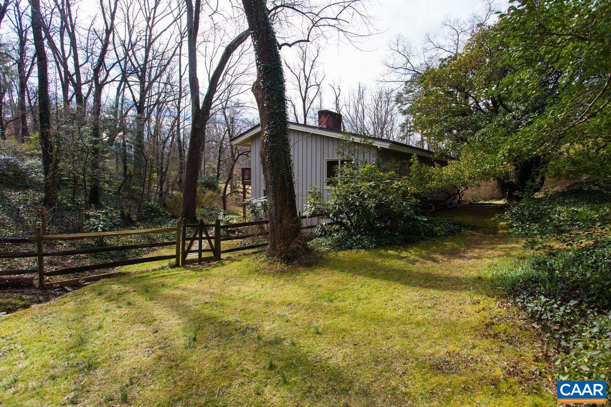 1521 Rugby Road Charlottesville, VA 22903 - Photo 6 of 27 a view of backyard with wooden fence and a bench