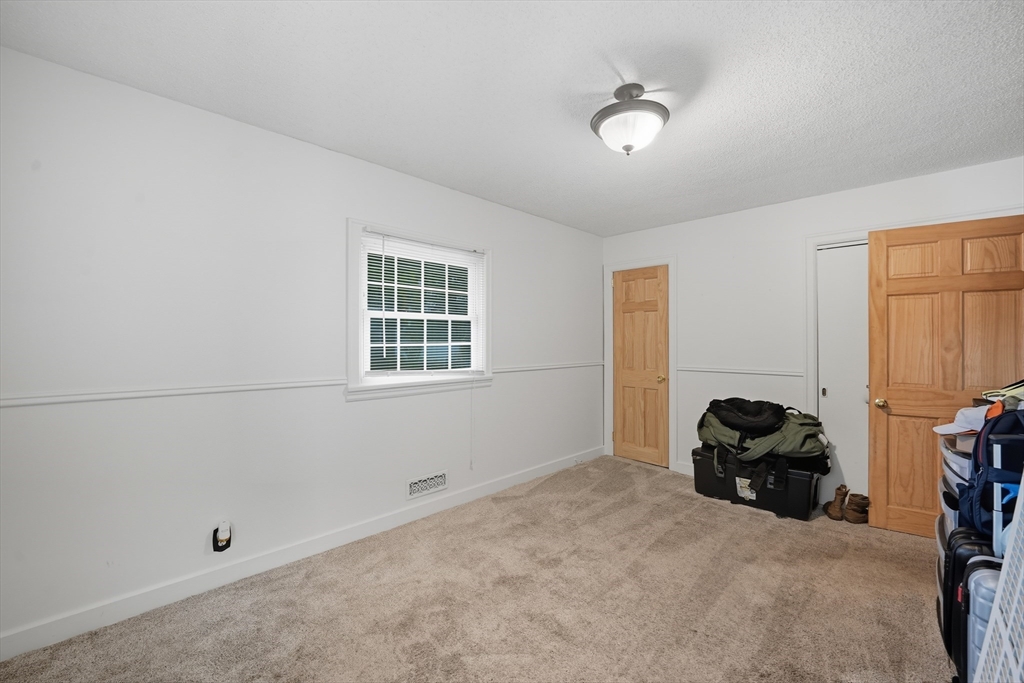 75 Carnavon Circle Springfield, MA 01109 - Photo 12 of 18 a bedroom with a bed and a window