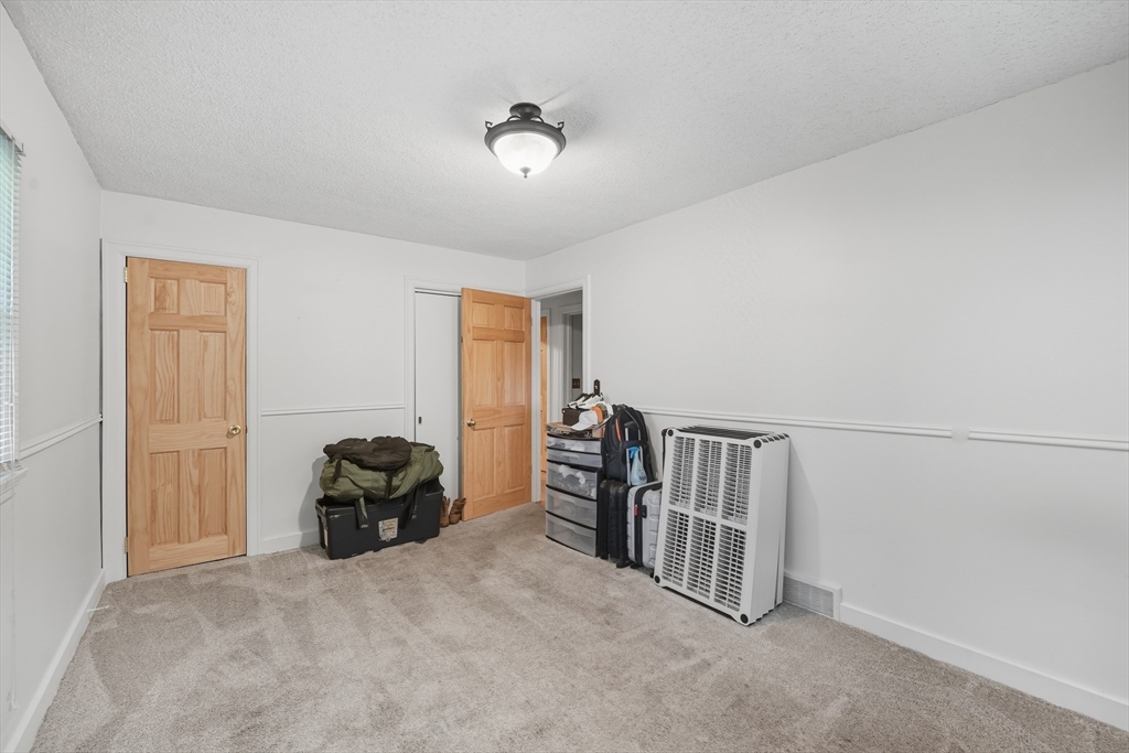 75 Carnavon Circle Springfield, MA 01109 - Photo 13 of 18 a view of a livingroom with a baby crib