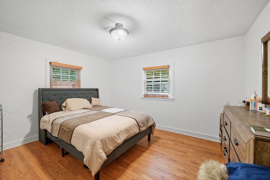 75 Carnavon Circle Springfield, MA 01109 - Photo 15 of 18 a large bed sitting in a bedroom next to a window with a dresser