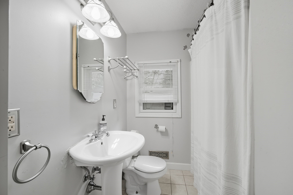 75 Carnavon Circle Springfield, MA 01109 - Photo 16 of 18 a bathroom with a toilet sink shower and mirror