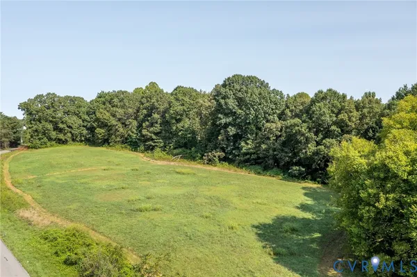 a view of a field with an trees in the background