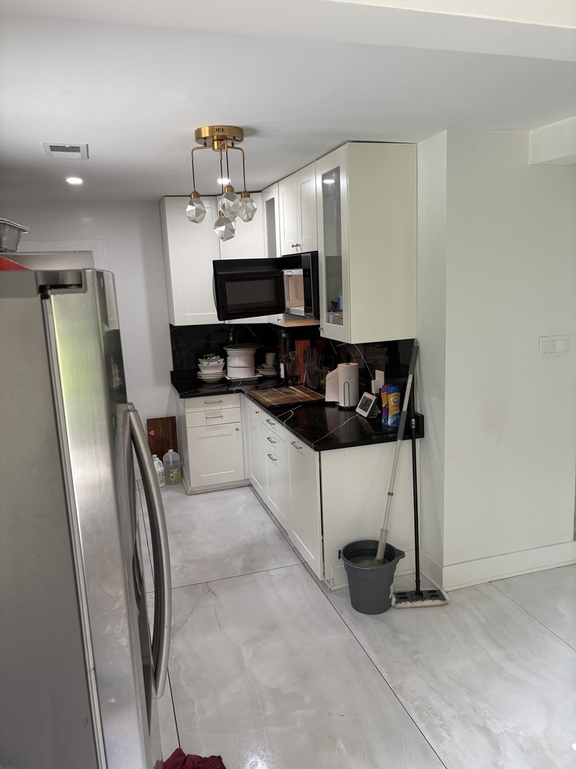 23000 Sherman Road Steger, IL 60475 - Photo 6 of 8 a kitchen with stainless steel appliances a refrigerator and a stove top oven