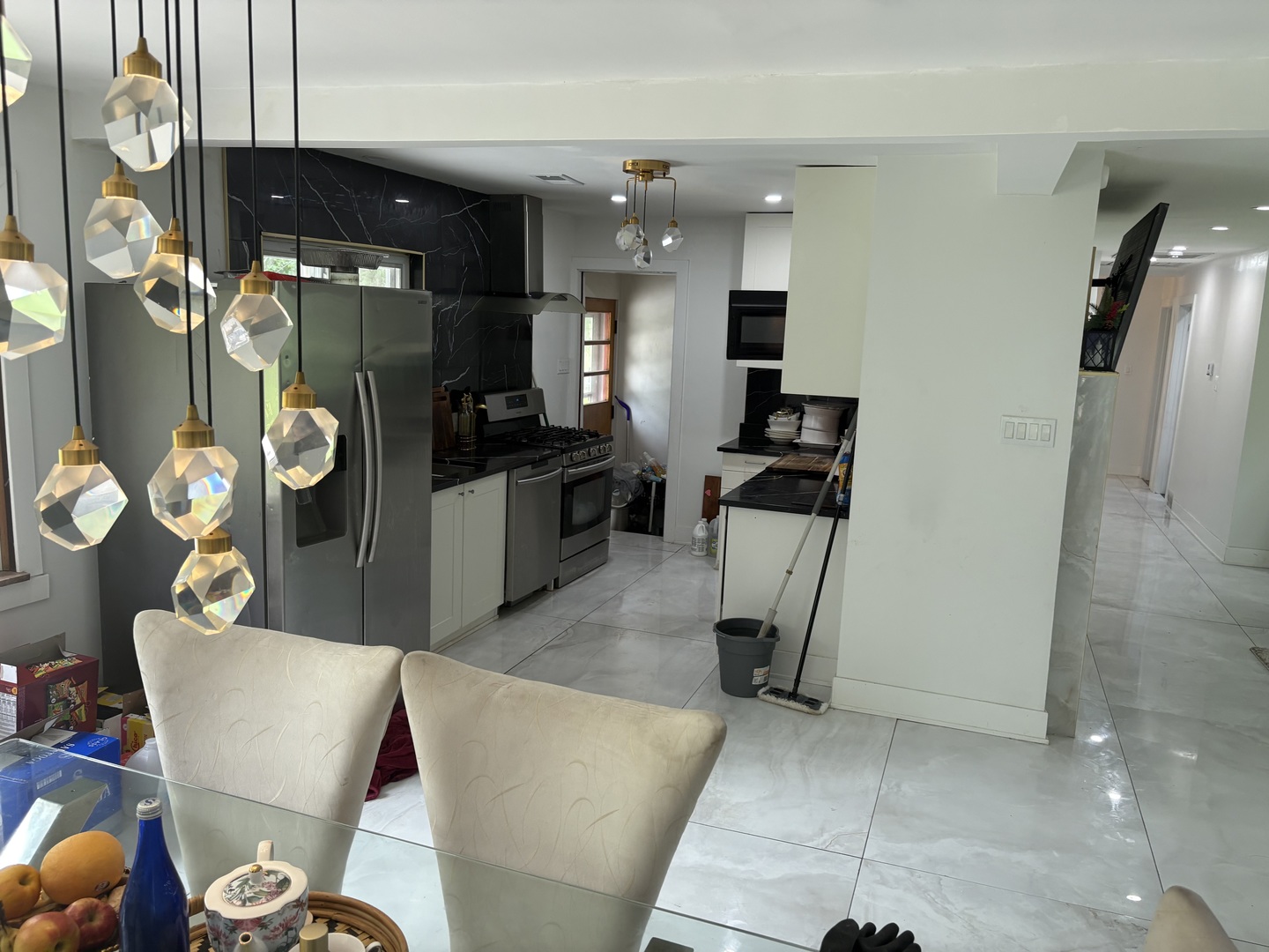 23000 Sherman Road Steger, IL 60475 - Photo 7 of 8 a living room with stainless steel appliances furniture a rug and a view of kitchen