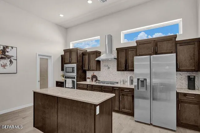 a kitchen with stainless steel appliances a refrigerator and a sink