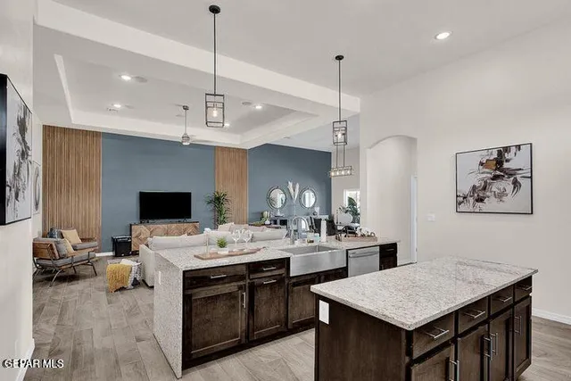 a kitchen with a stove a counter space dining table and chairs