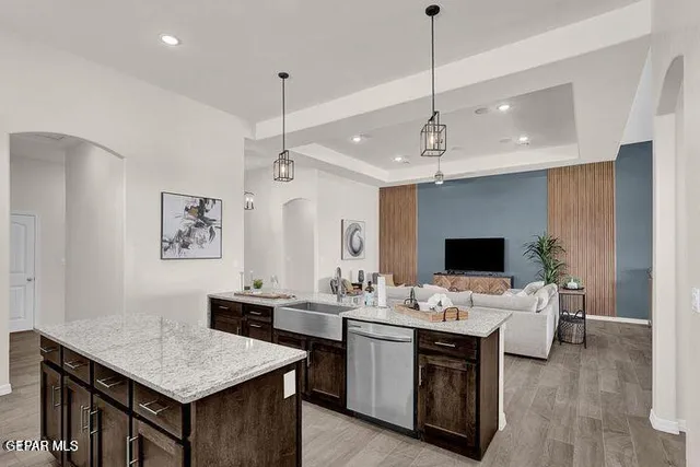 a room with a table chairs a computer and a chandelier