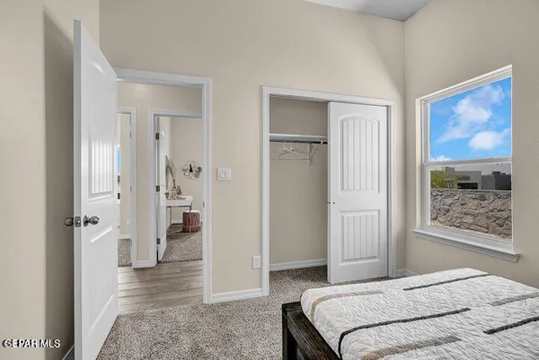 a bedroom with a bed and glass door