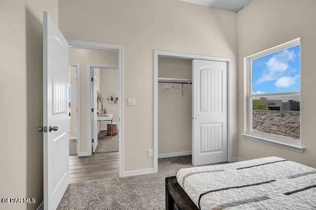 a bedroom with a bed and glass door