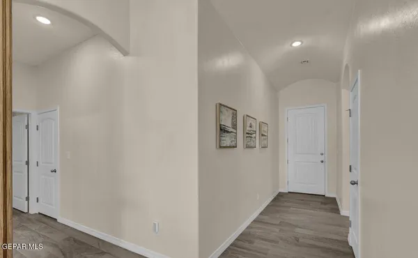 a view of a hallway with wooden floor