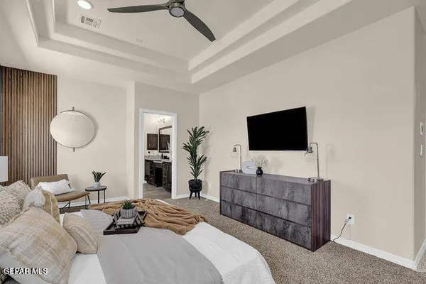 a living room with furniture a flat screen tv and a chandelier
