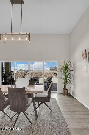 a dining room with furniture and wooden floor