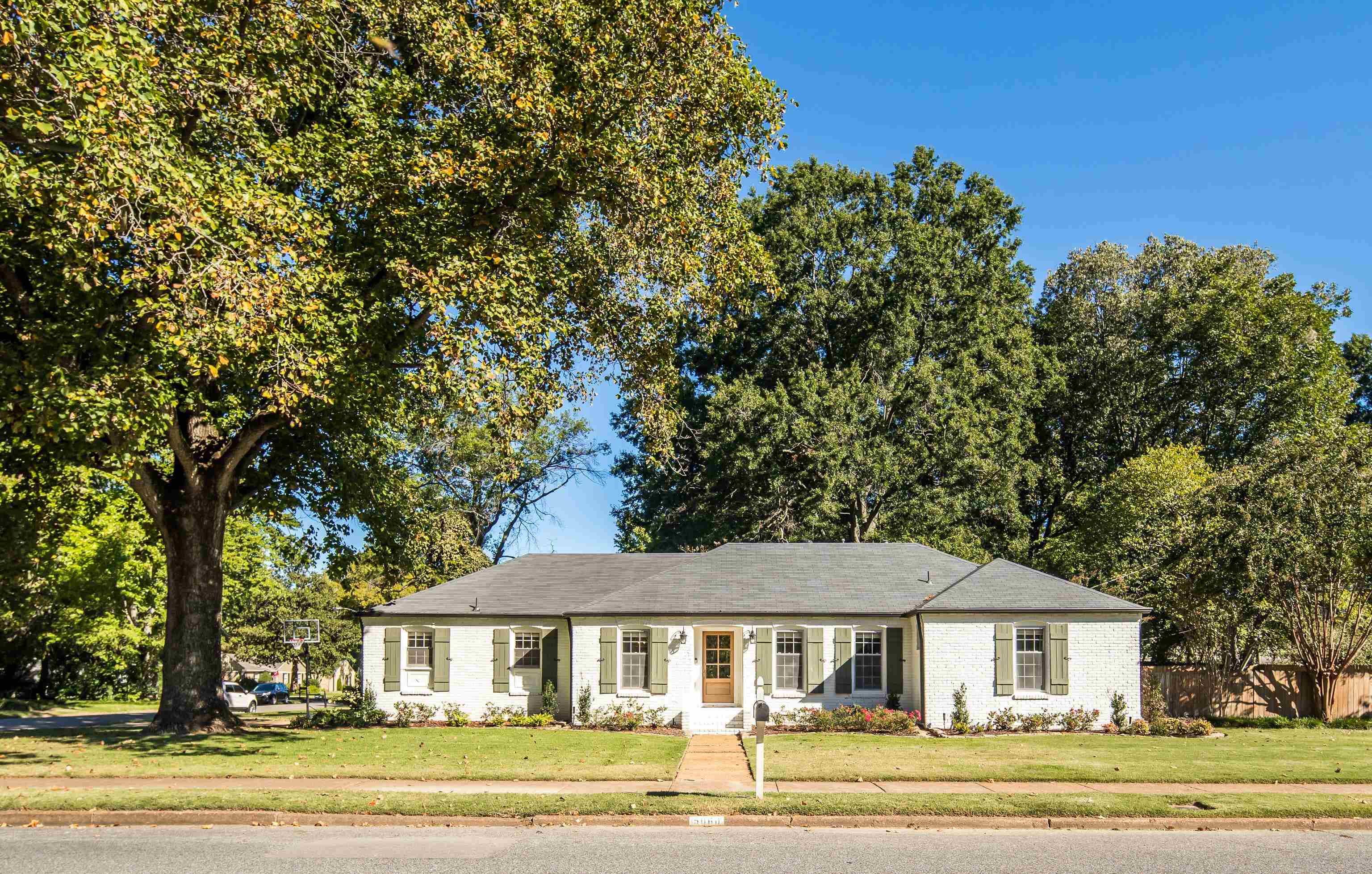 a front view of a house with a garden
