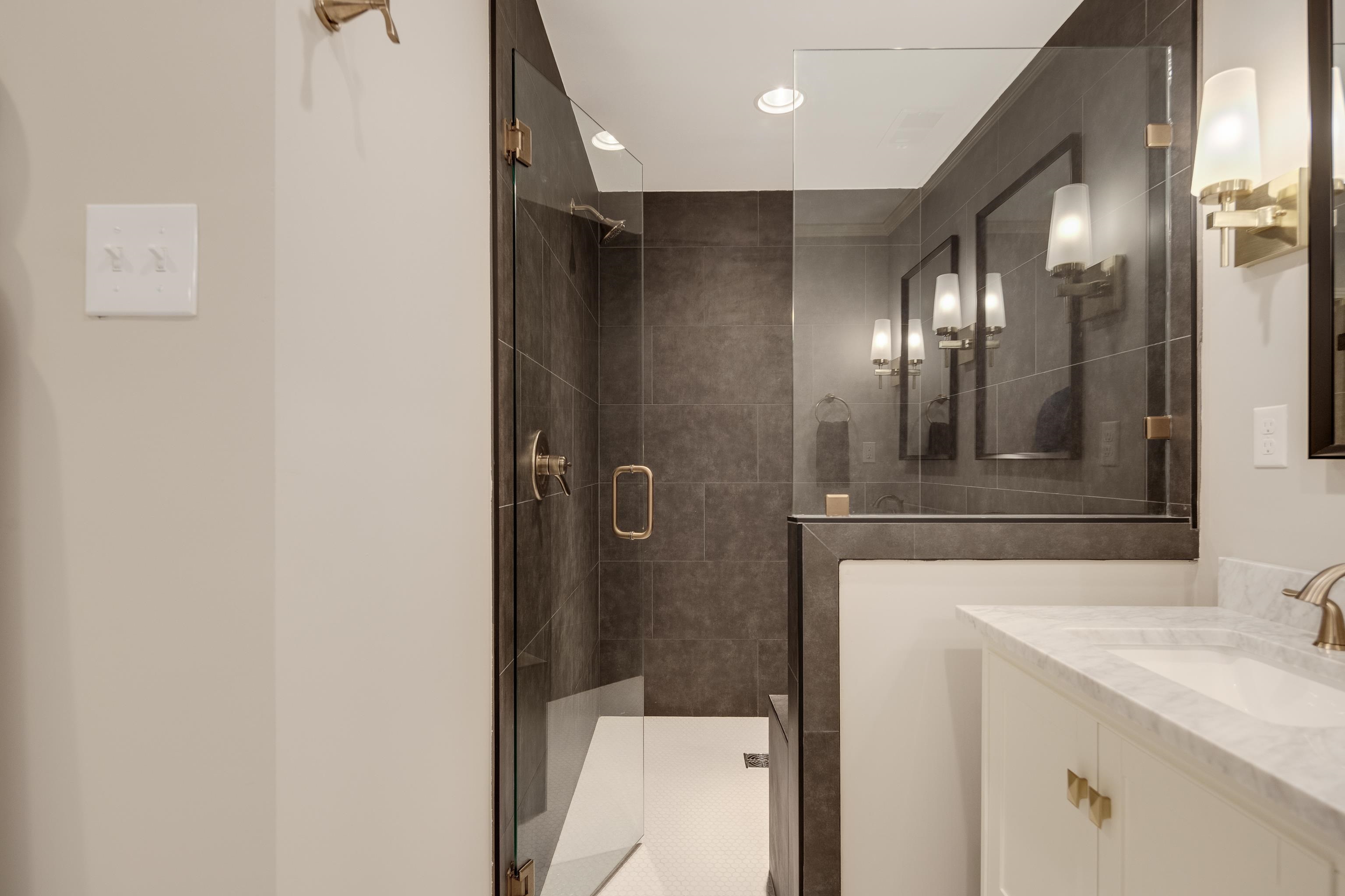 5060 Rich Road Memphis, TN 38117 - Photo 15 of 25 a bathroom with a mirror and a shower