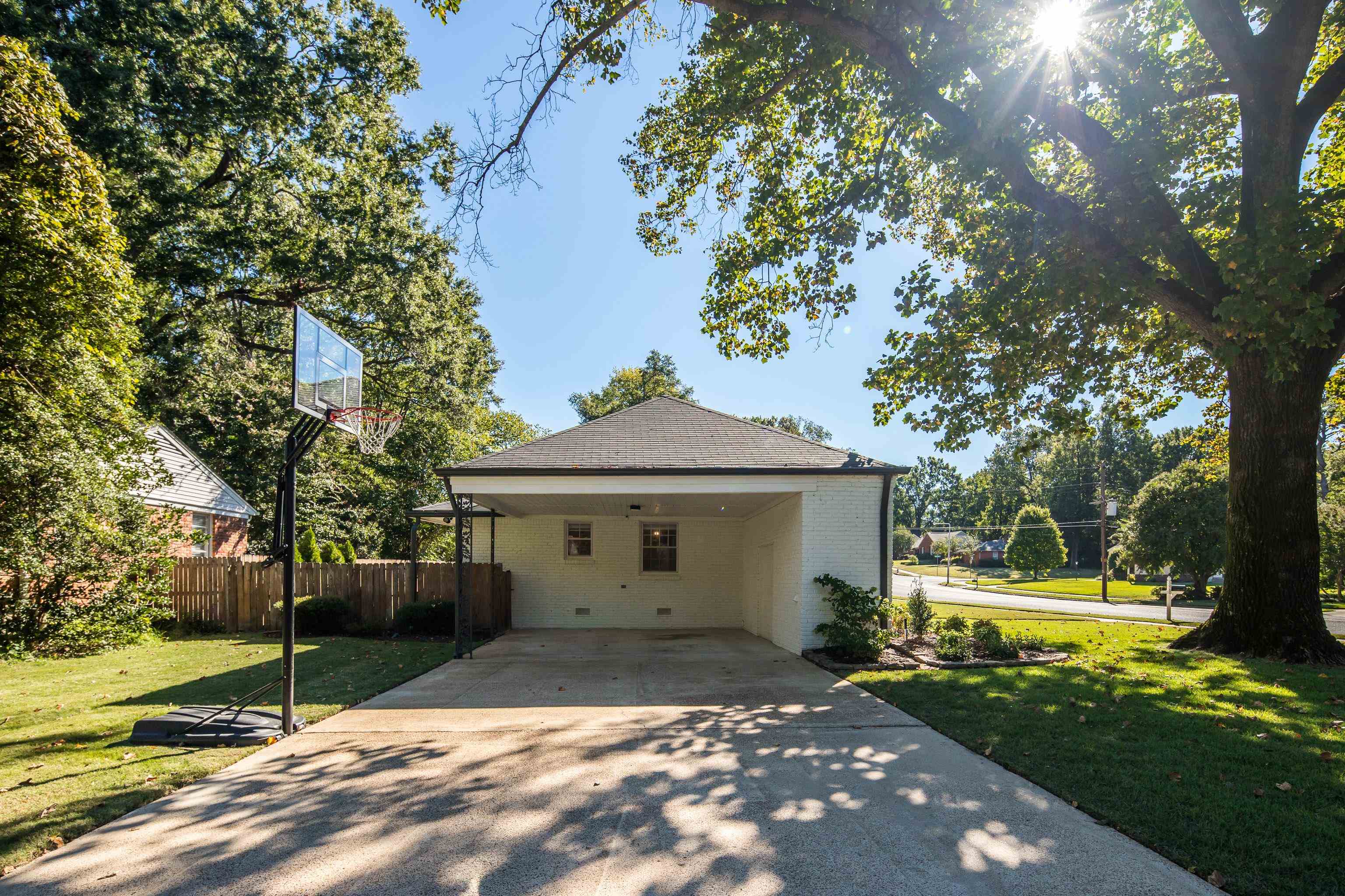 5060 Rich Road Memphis, TN 38117 - Photo 25 of 25 a view of a house with backyard and a tree