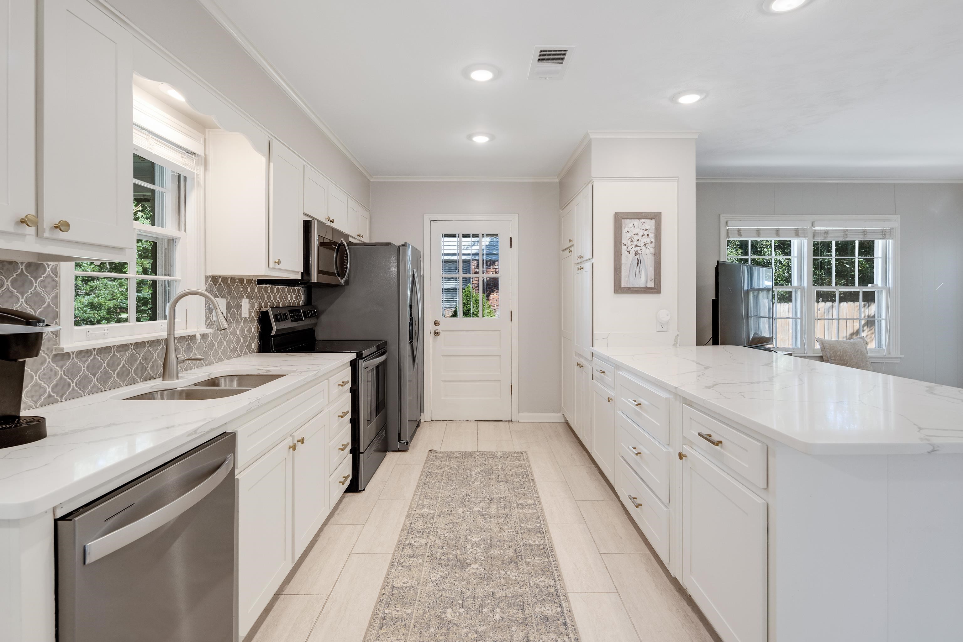 5060 Rich Road Memphis, TN 38117 - Photo 10 of 25 a large white kitchen with cabinets