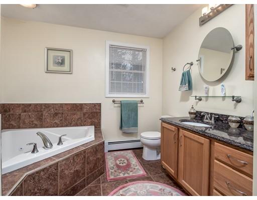 151 Groton Road Chelmsford, MA 01863 - Photo 11 of 29 a bathroom with a granite countertop toilet a sink and a bathtub