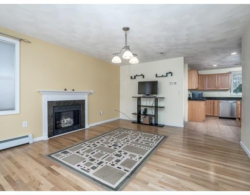 151 Groton Road Chelmsford, MA 01863 - Photo 8 of 29 a living room with kitchen furniture and a fireplace