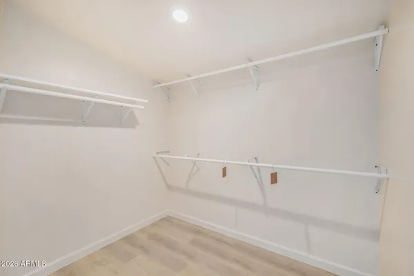 a bathroom with a toilet a sink a mirror and vanity