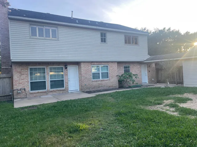 a front view of a house with a garden and yard