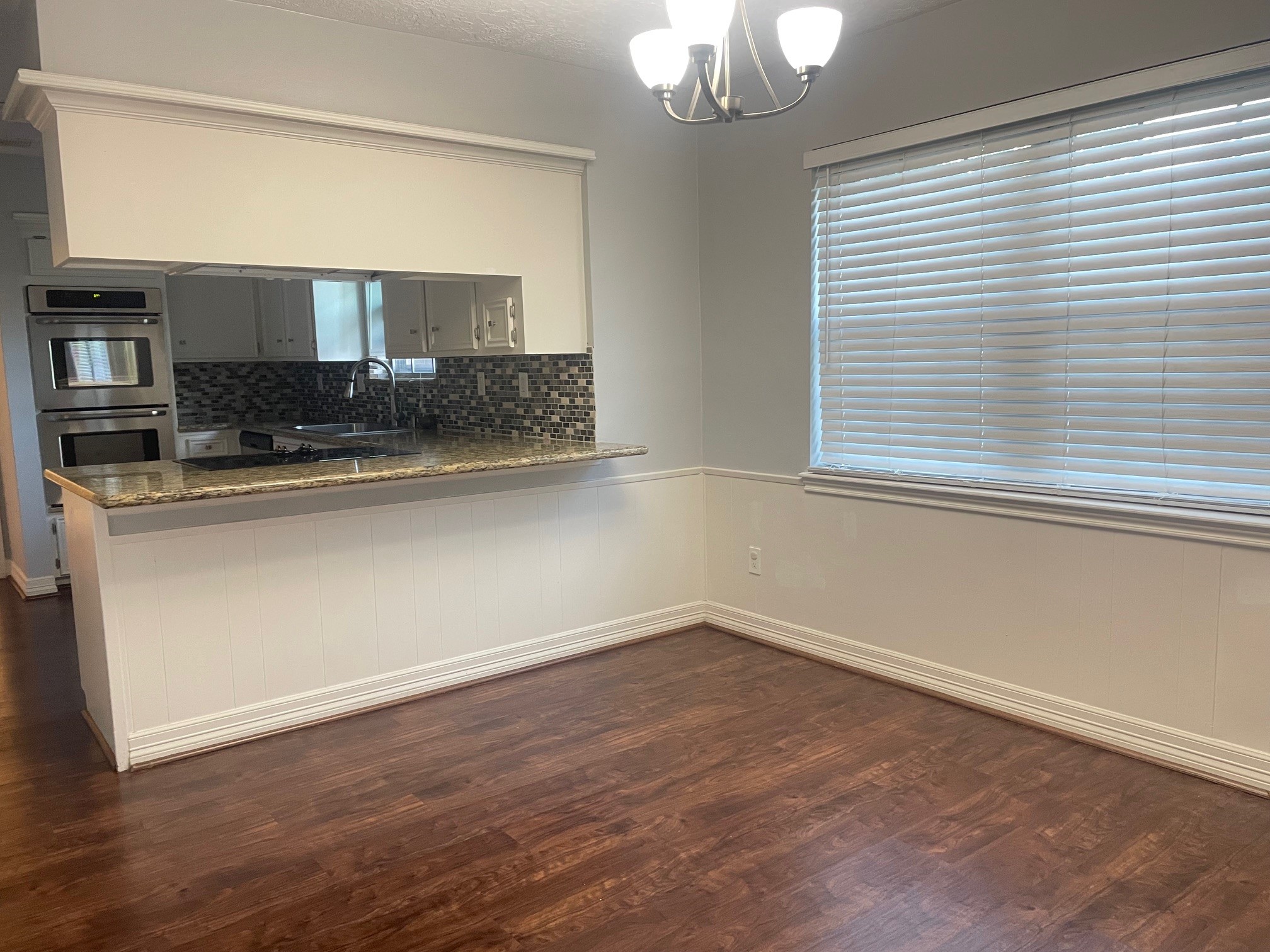 11310 Meadow Lake Drive Houston, TX 77077 - Photo 3 of 16 an empty room with wooden floor and window