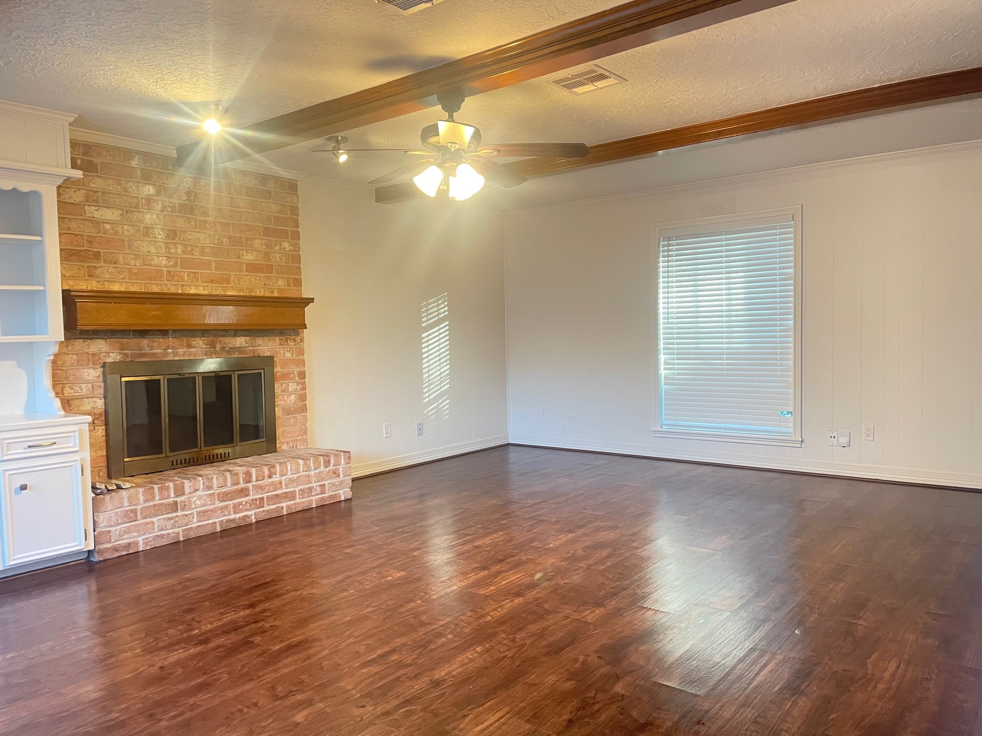 11310 Meadow Lake Drive Houston, TX 77077 - Photo 5 of 16 a view of an empty room with a fireplace and a window