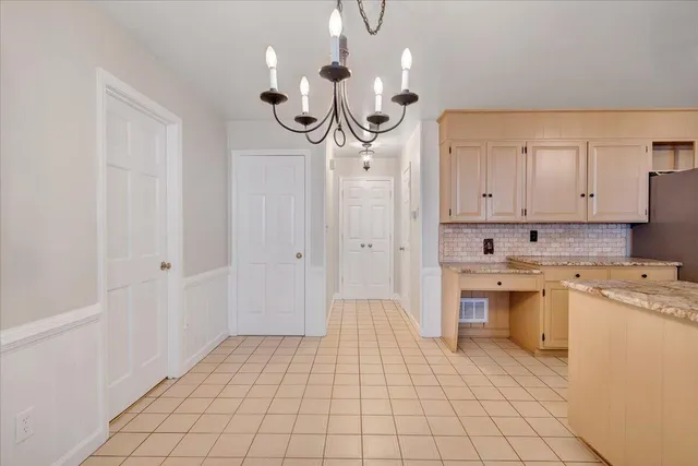 a view of a pathway of a house with wooden fence