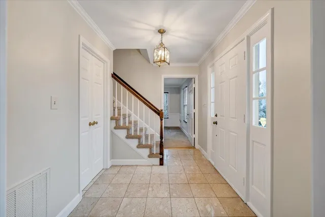 a kitchen with white cabinets appliances and a sink