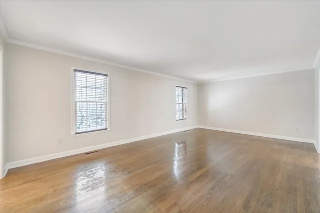 a large white kitchen with cabinets