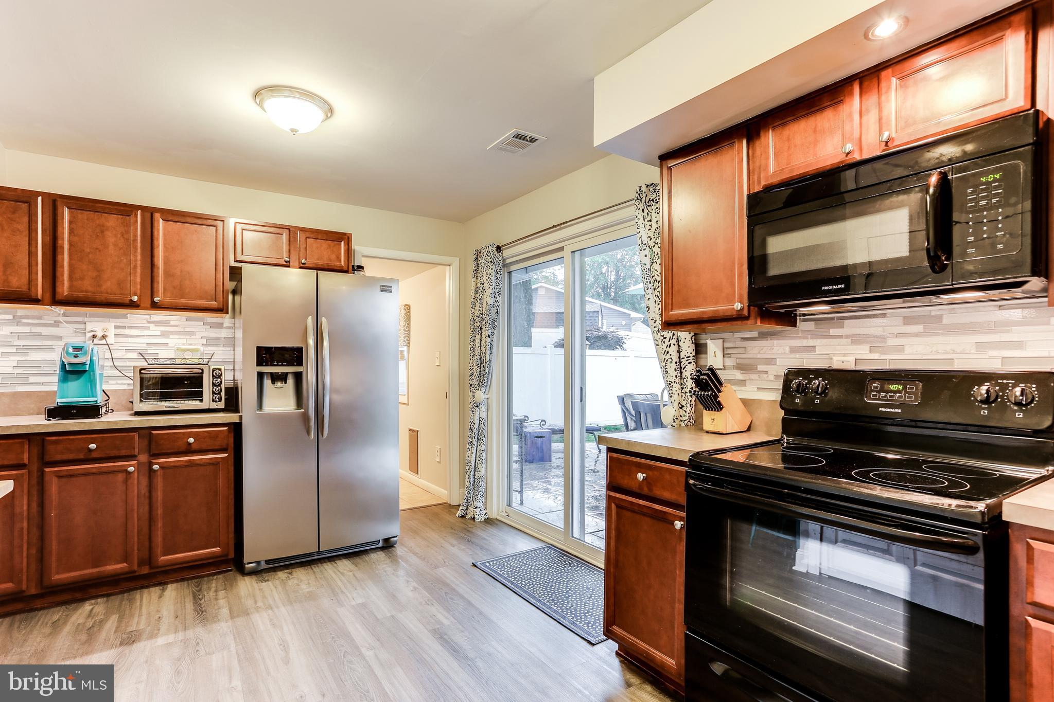 7894 Chalice Road Severn, MD 21144 - Photo 9 of 30 Bright Kitchen w/ Sliders to Rear Patio