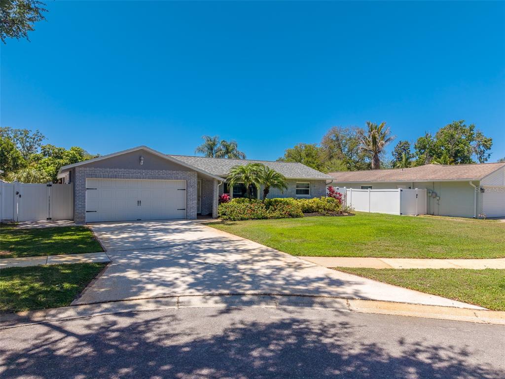 9628 122nd Way Seminole, FL 33772 - Photo 1 of 53 a front view of house with yard and trees in the background