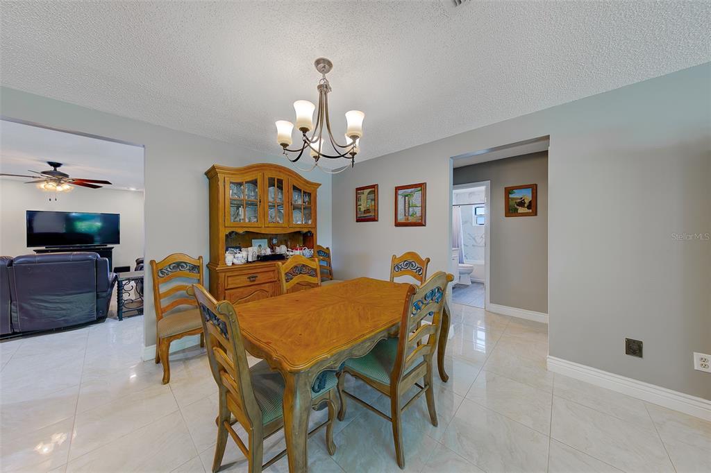 9628 122nd Way Seminole, FL 33772 - Photo 12 of 53 a view of a dining room with furniture and wooden floor