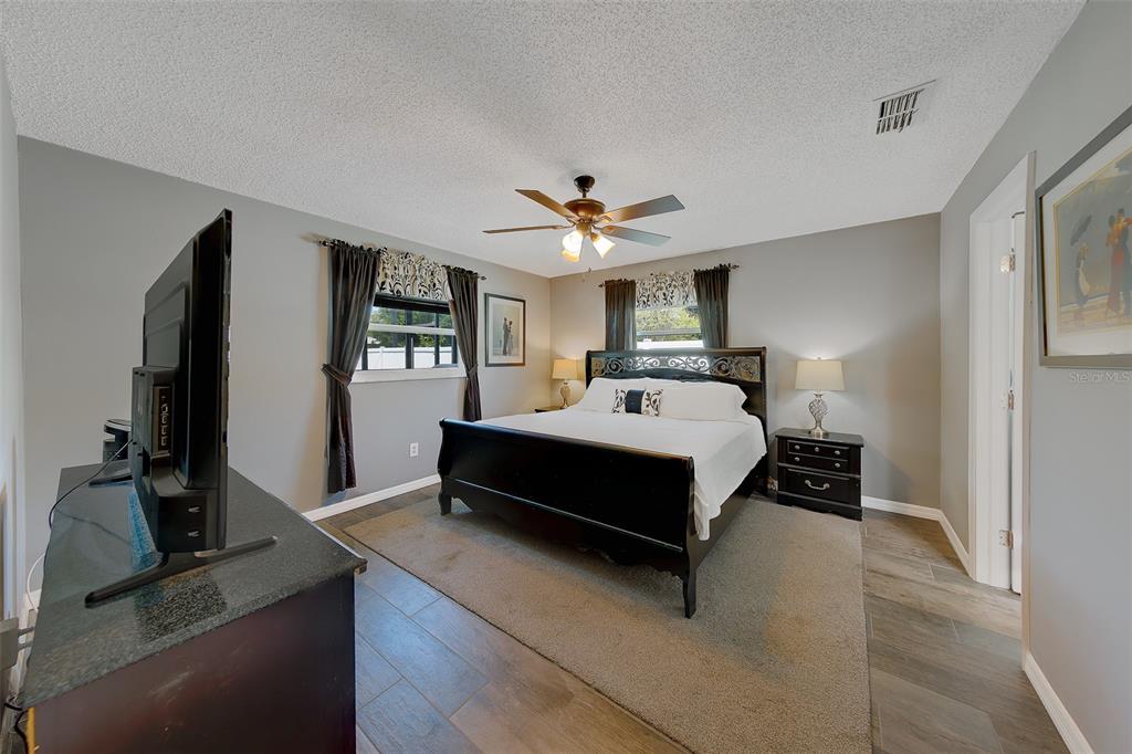 9628 122nd Way Seminole, FL 33772 - Photo 13 of 53 a bedroom with a bed a window and a flat screen television