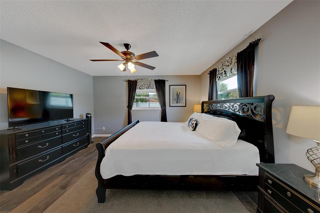9628 122nd Way Seminole, FL 33772 - Photo 14 of 53 a bedroom with a bed and a flat screen tv