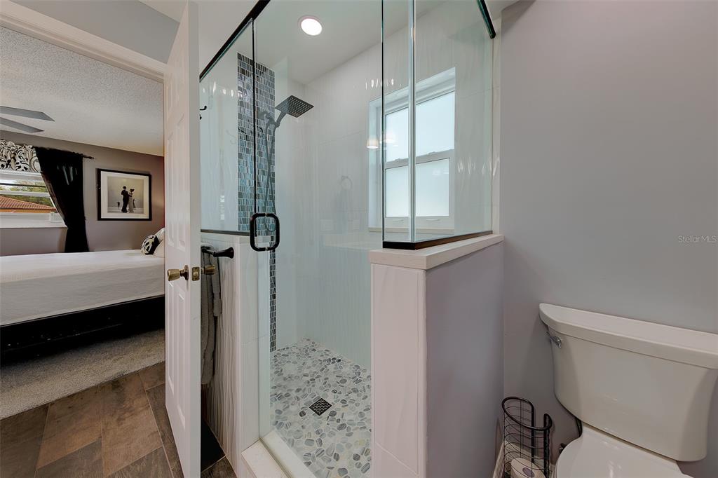 9628 122nd Way Seminole, FL 33772 - Photo 17 of 53 a bathroom with a shower toilet and sink
