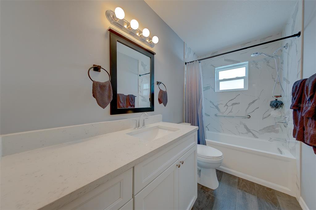 9628 122nd Way Seminole, FL 33772 - Photo 20 of 53 a bathroom with a sink a toilet and bathtub