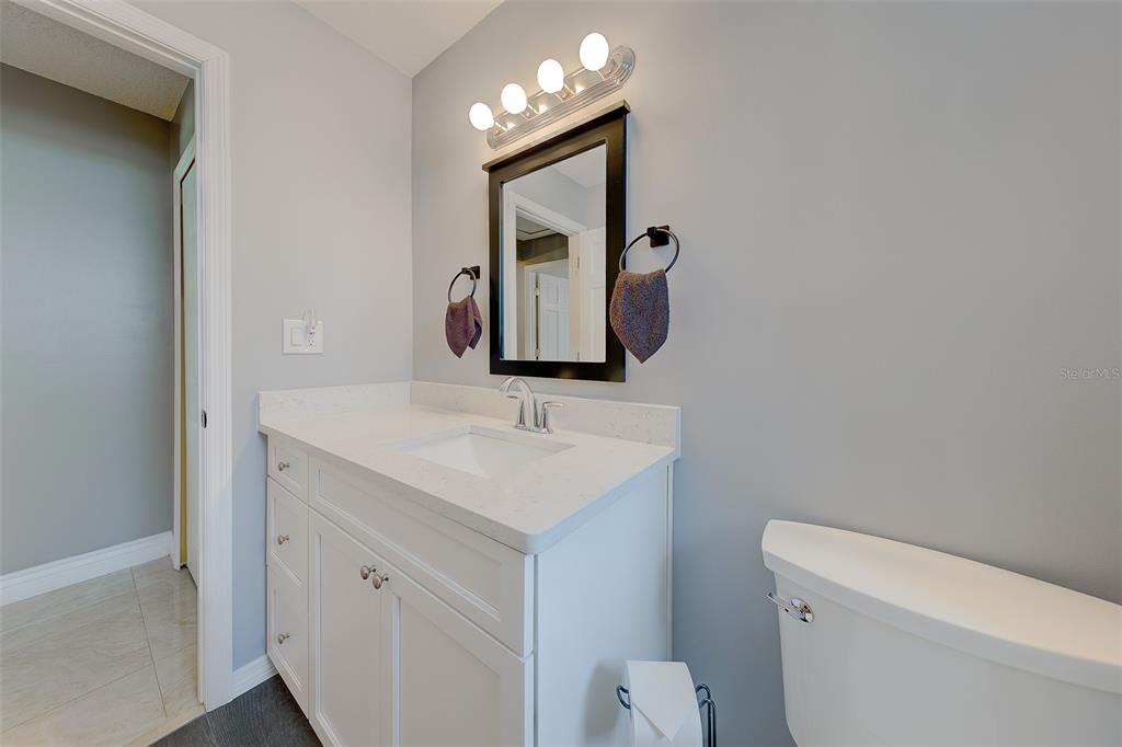 9628 122nd Way Seminole, FL 33772 - Photo 21 of 53 a bathroom with a toilet sink and mirror
