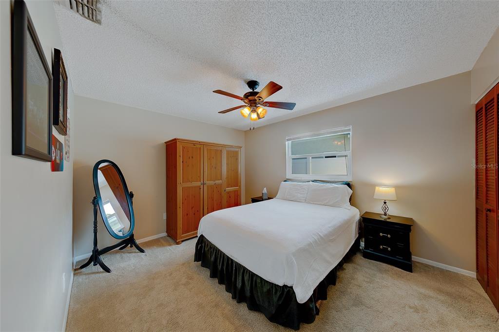 9628 122nd Way Seminole, FL 33772 - Photo 22 of 53 a bedroom with a bed and a chandelier
