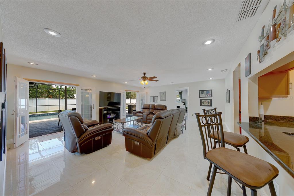 9628 122nd Way Seminole, FL 33772 - Photo 26 of 53 a living room with furniture and a flat screen tv