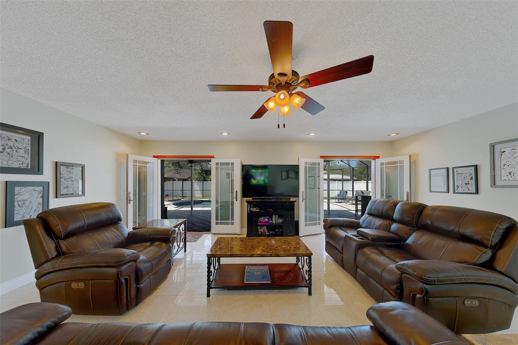 9628 122nd Way Seminole, FL 33772 - Photo 28 of 53 a living room with furniture and a flat screen tv