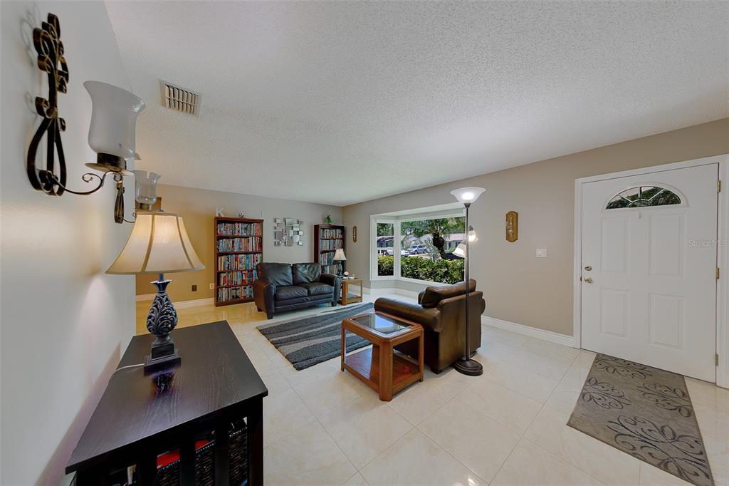 9628 122nd Way Seminole, FL 33772 - Photo 3 of 53 a living room with furniture and a flat screen tv