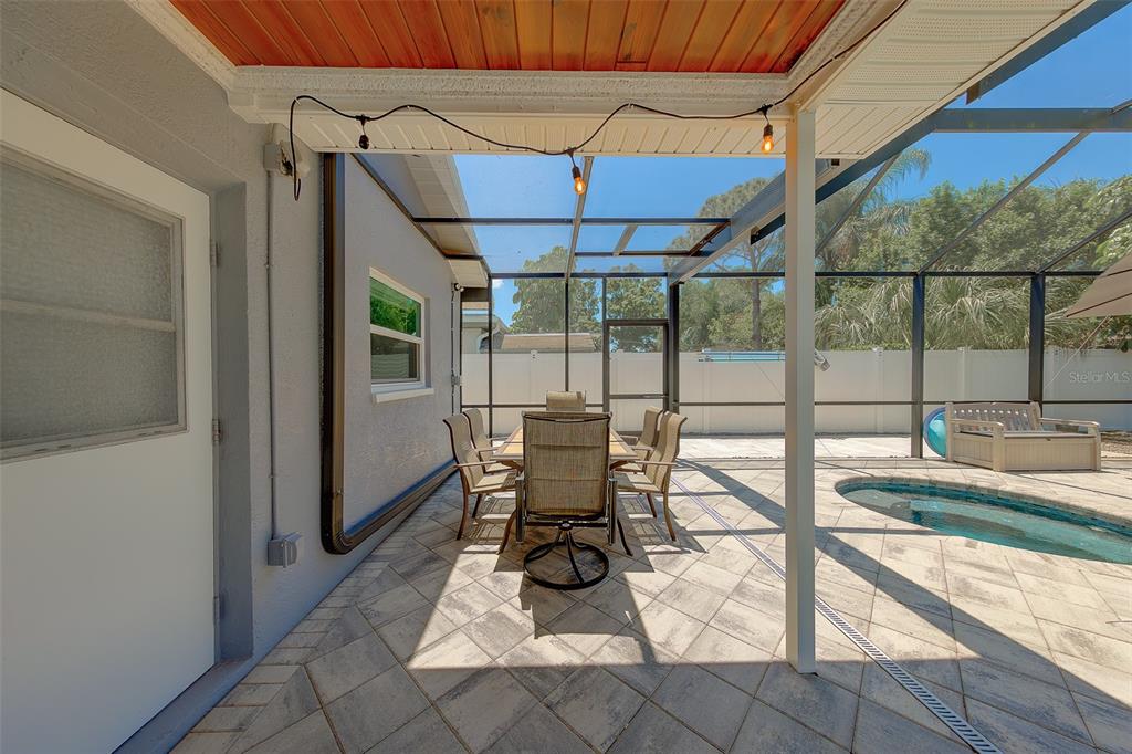 9628 122nd Way Seminole, FL 33772 - Photo 37 of 53 a view of a patio with table and chairs under an umbrella