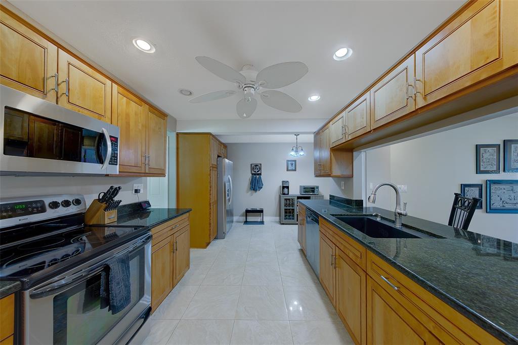 9628 122nd Way Seminole, FL 33772 - Photo 6 of 53 a kitchen with a sink stove top oven and cabinets