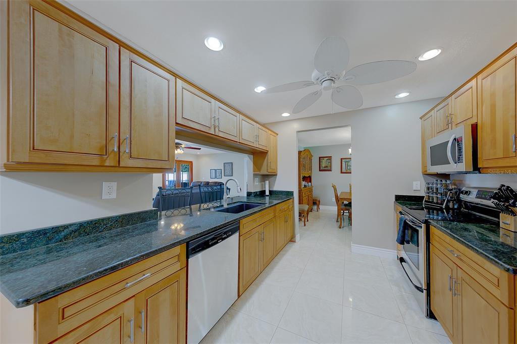 9628 122nd Way Seminole, FL 33772 - Photo 7 of 53 a kitchen with lots of counter top space and stainless steel appliances