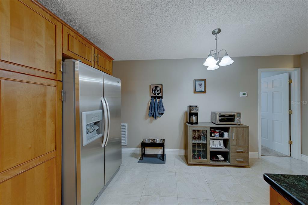 9628 122nd Way Seminole, FL 33772 - Photo 8 of 53 a view of a kitchen with fridge and workspace